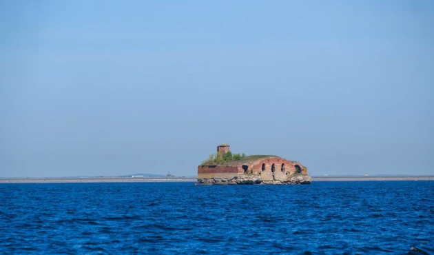 A powder magazine sticking out of the water alone