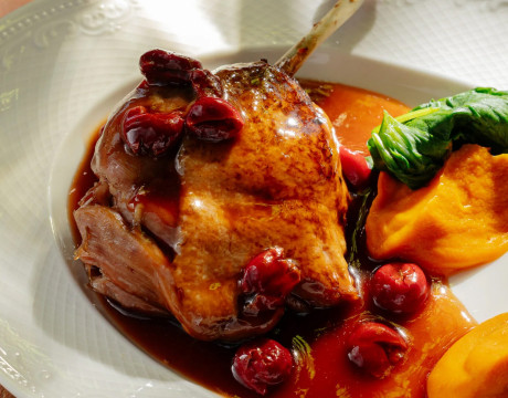 Duck leg confit with carrot mash and cherries